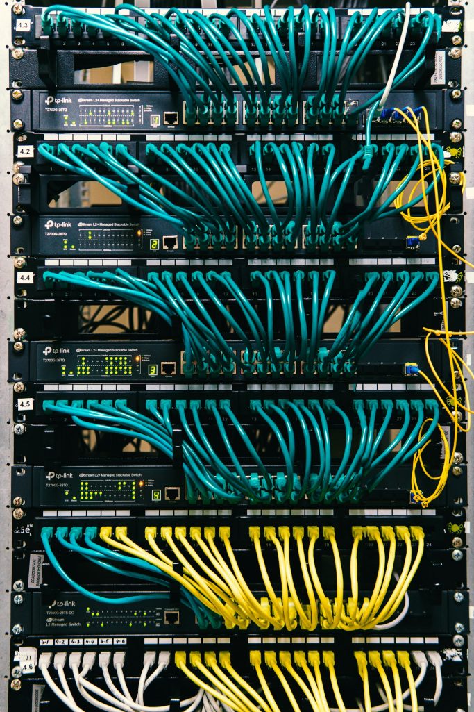 Close-up of server racks with colorful network cables organized neatly.